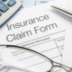 Insurance claim form on desk with other items