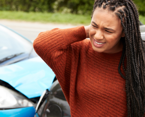Woman holding her neck after a car accident